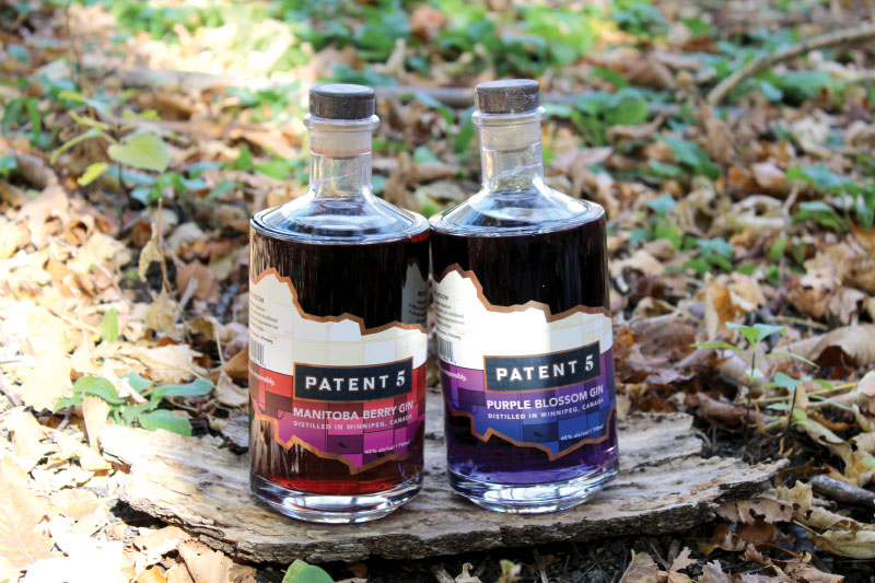 Two bottles of liquor on piece of rustic wood