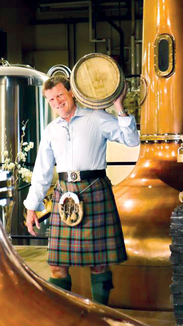 Graeme Macaloney hoisting barrel on shoulder