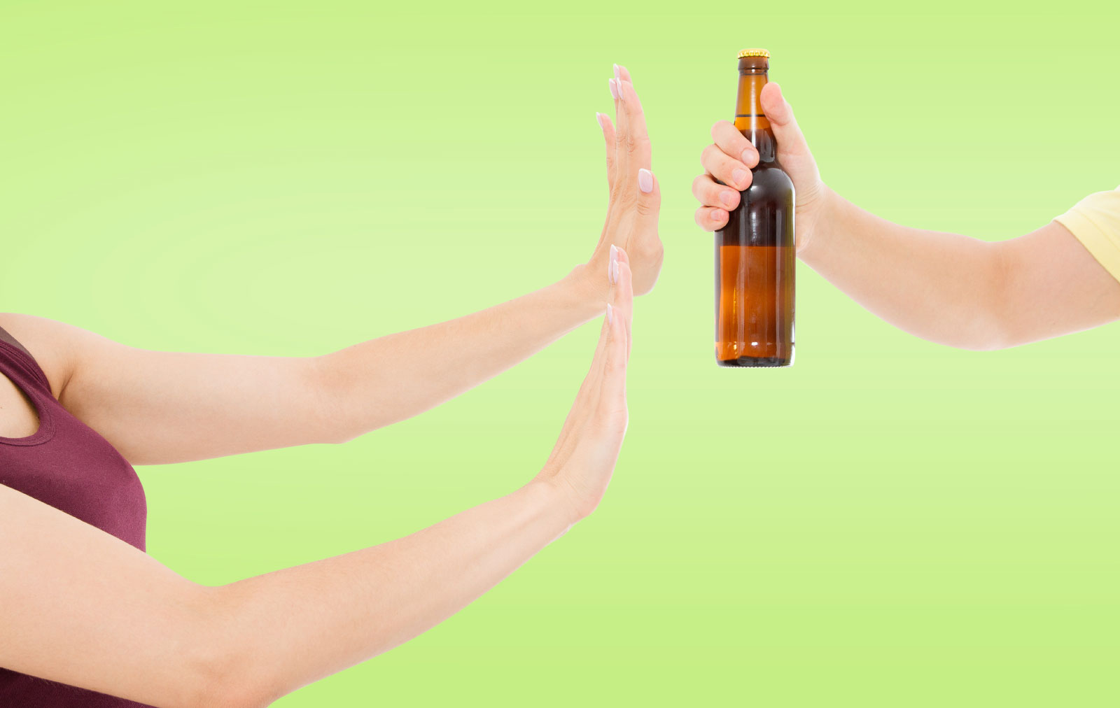 Person rejecting bottle of beer being handed to them