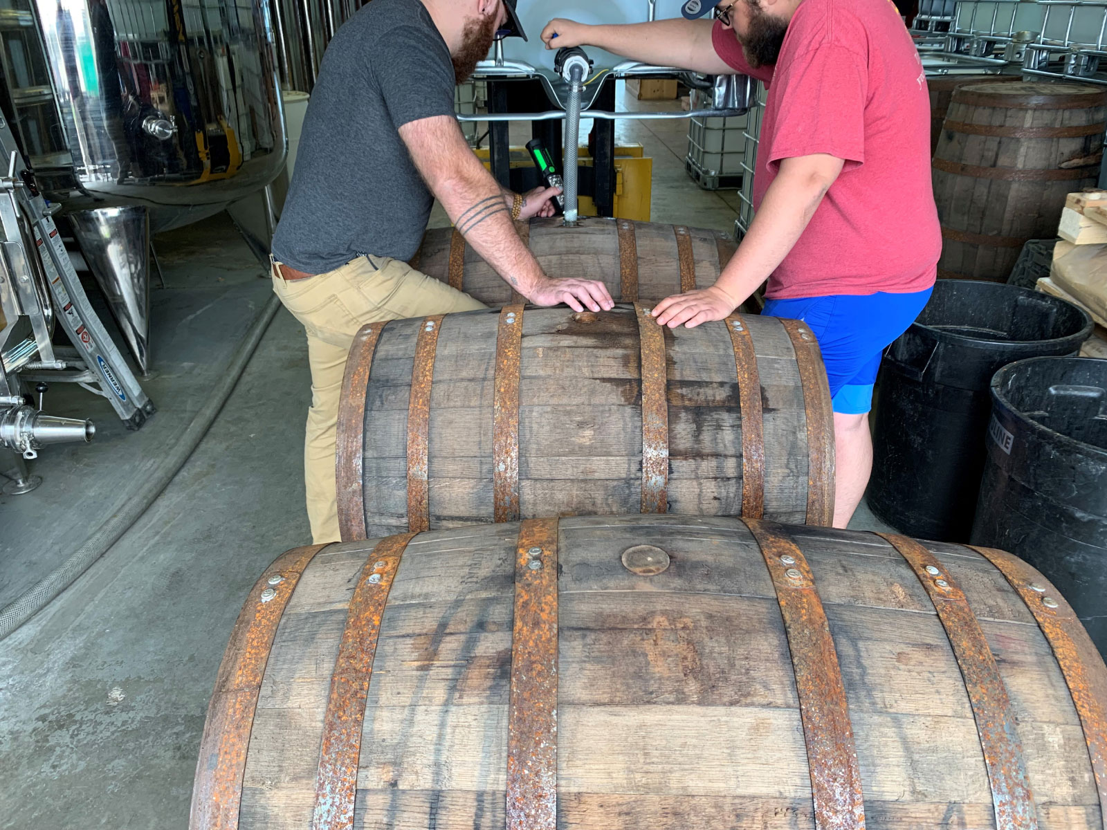 Two gents filling barrels