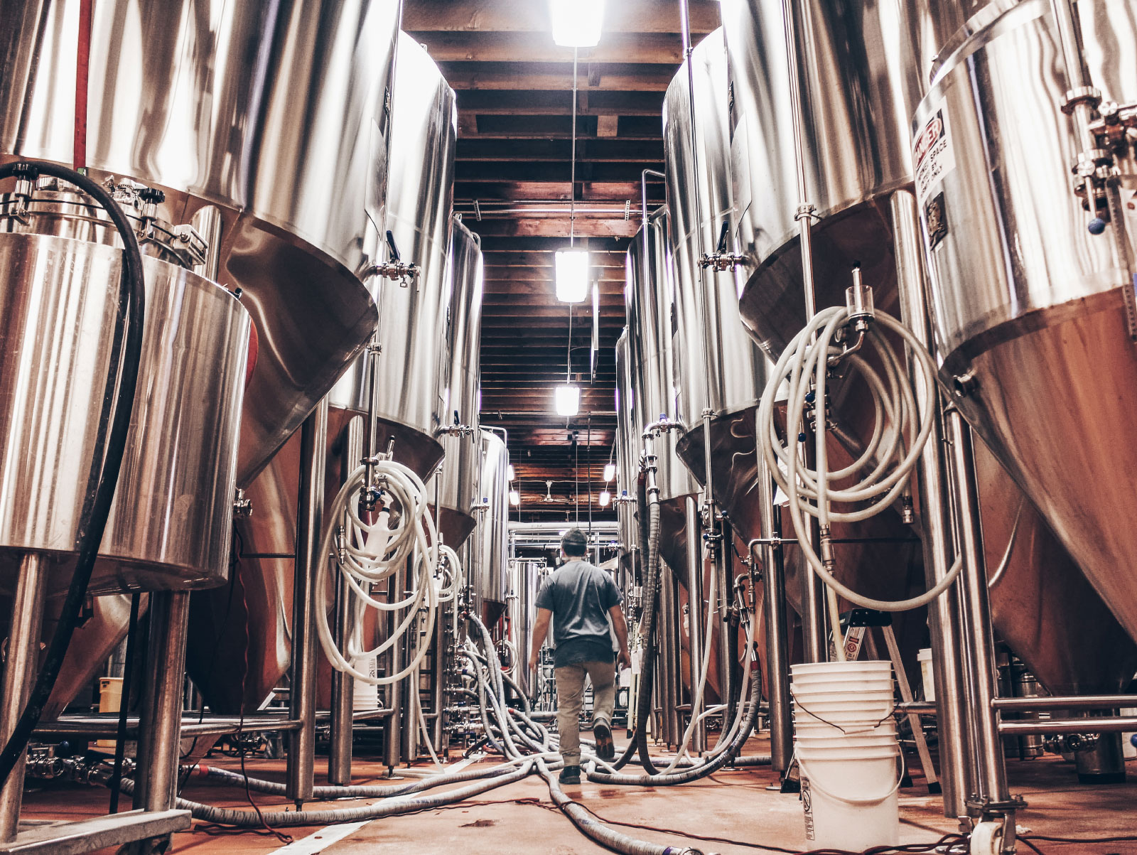 Man walking between large stills