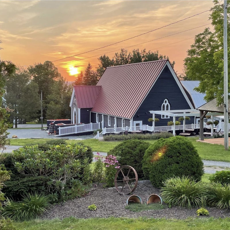 Exterior photo of Avondale Sky Winery with sun setting in background