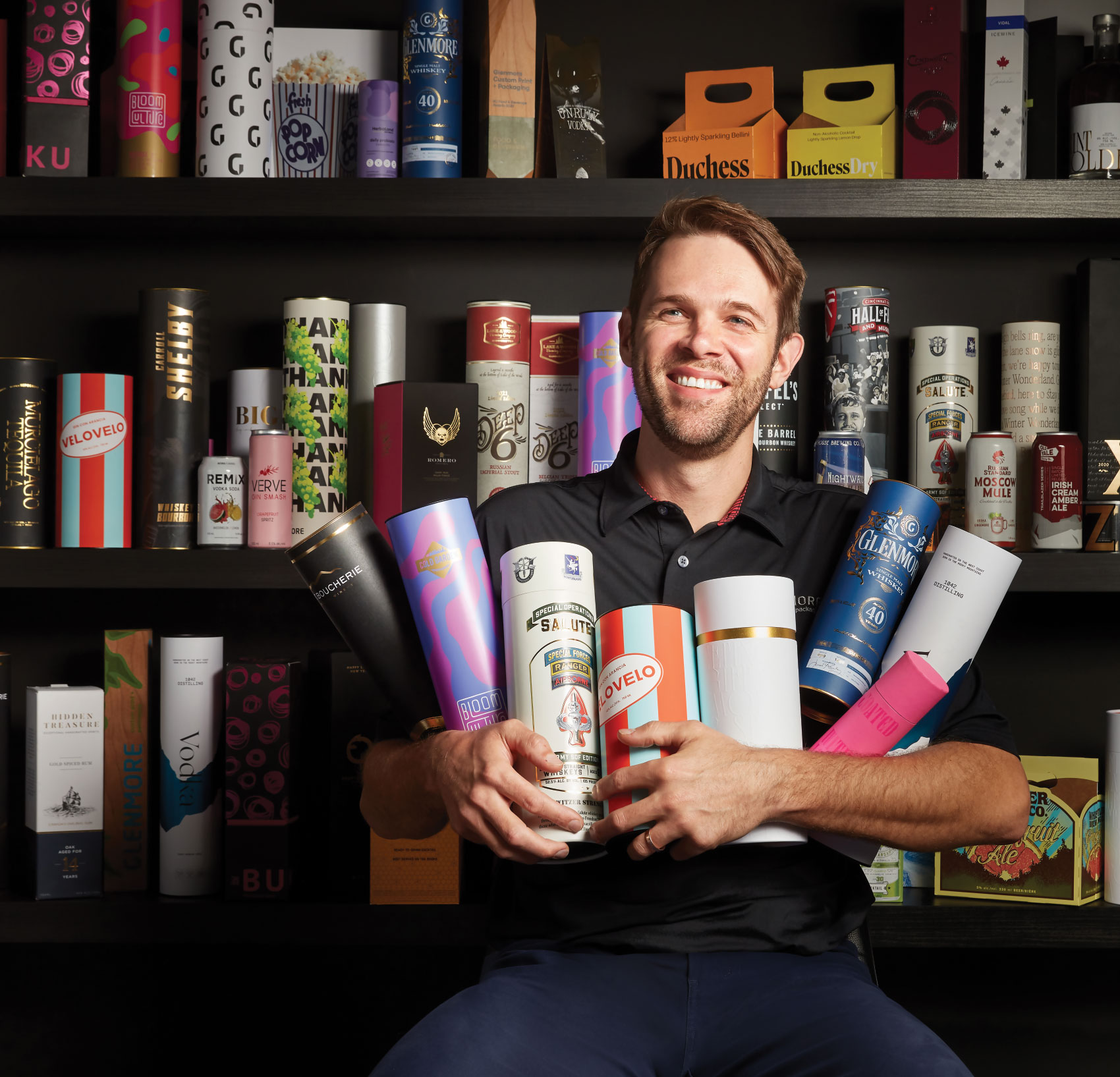 James Rowley with armful of various beverage packaging