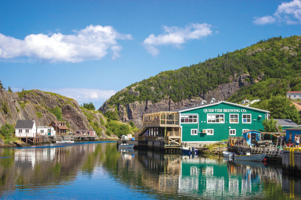 Exterior of Quidi Vidi Brewery Co. with mountains in background 