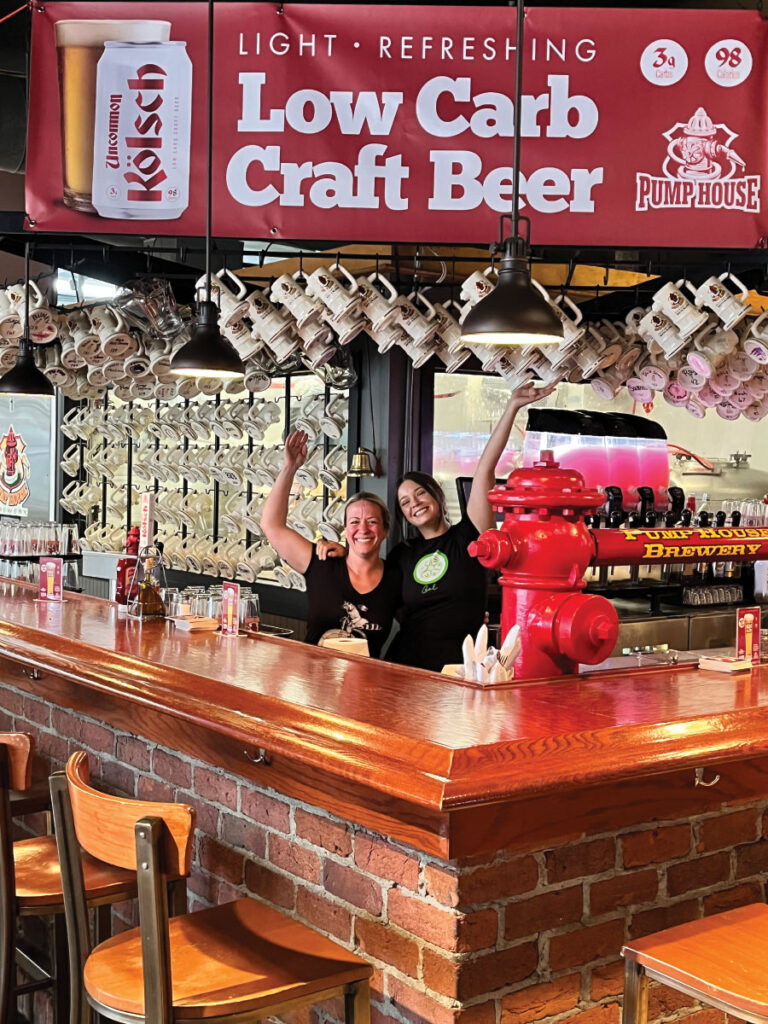 Staff smiling behind bar