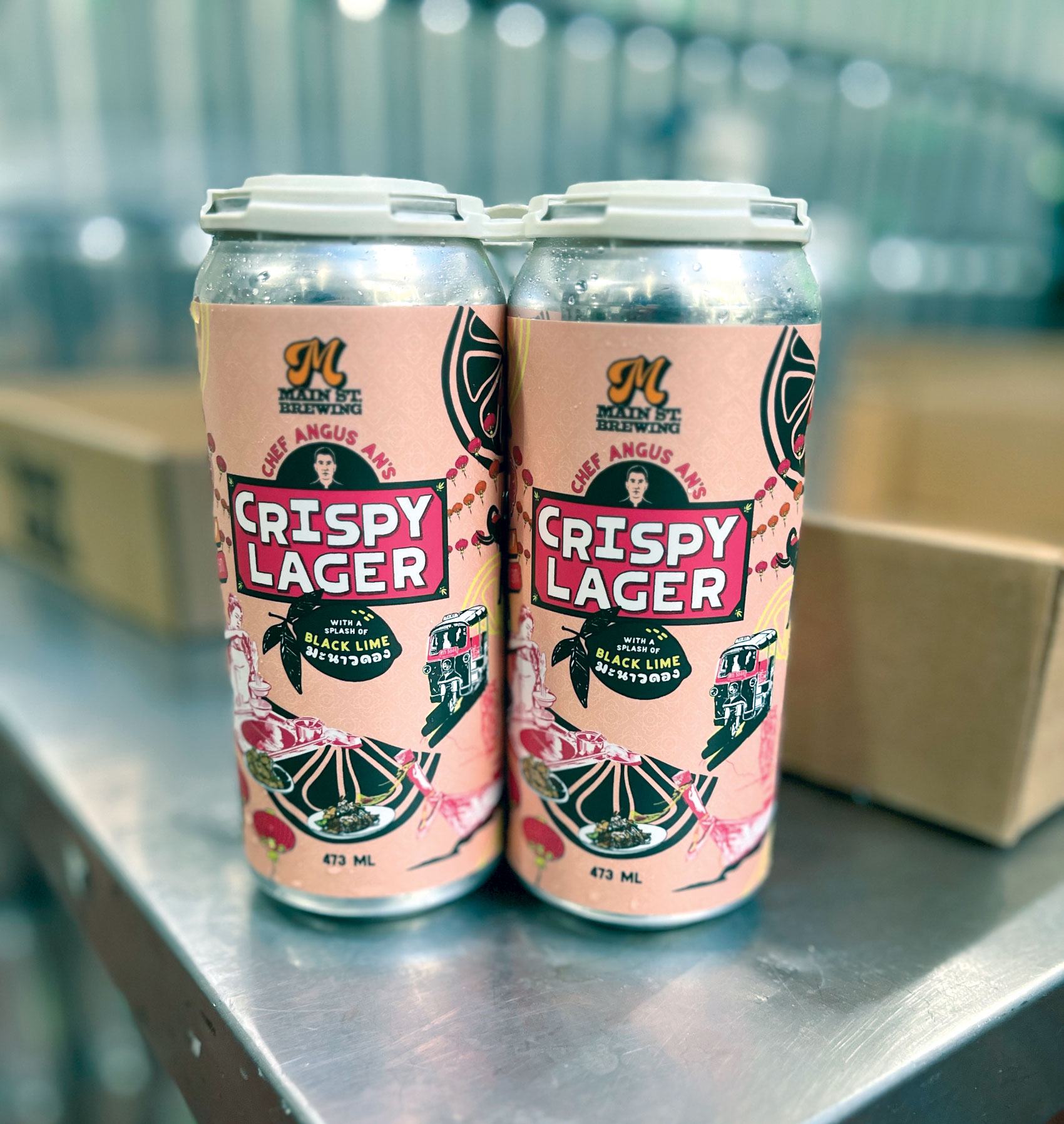 Two cans of Crispy Lager on table