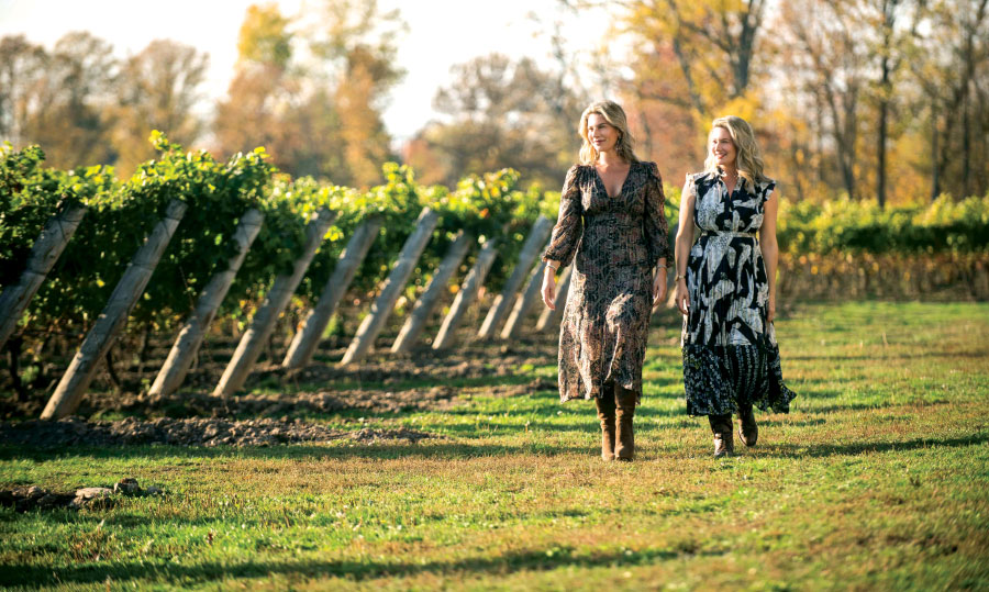 Angela and Melissa walking in vineyard