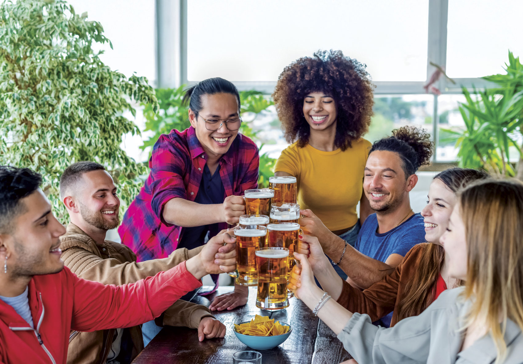 Group of young adults raising their glasses for a toast