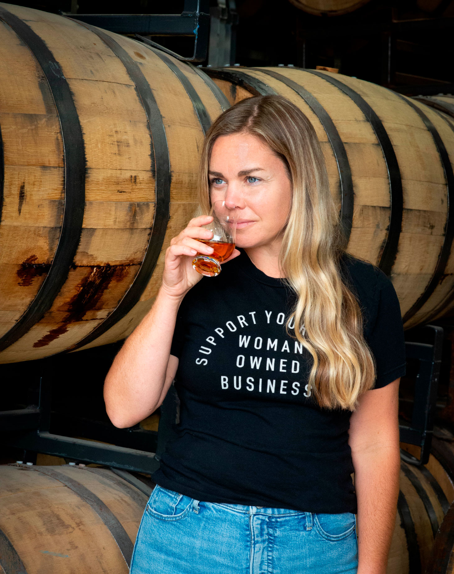 Ashley Graham inspecting whisky from barrel