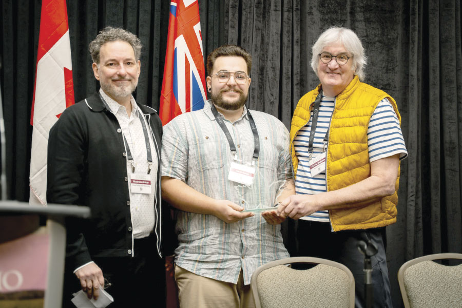Max Kaiser and Jacob Kaiser presenting award to Thomas Bachelder