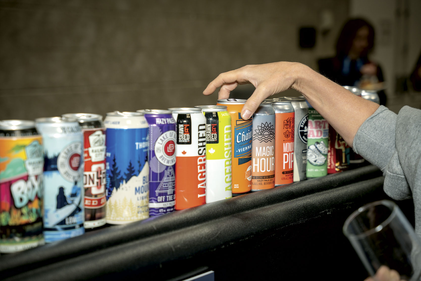 Various colourful cans of beer on shelf