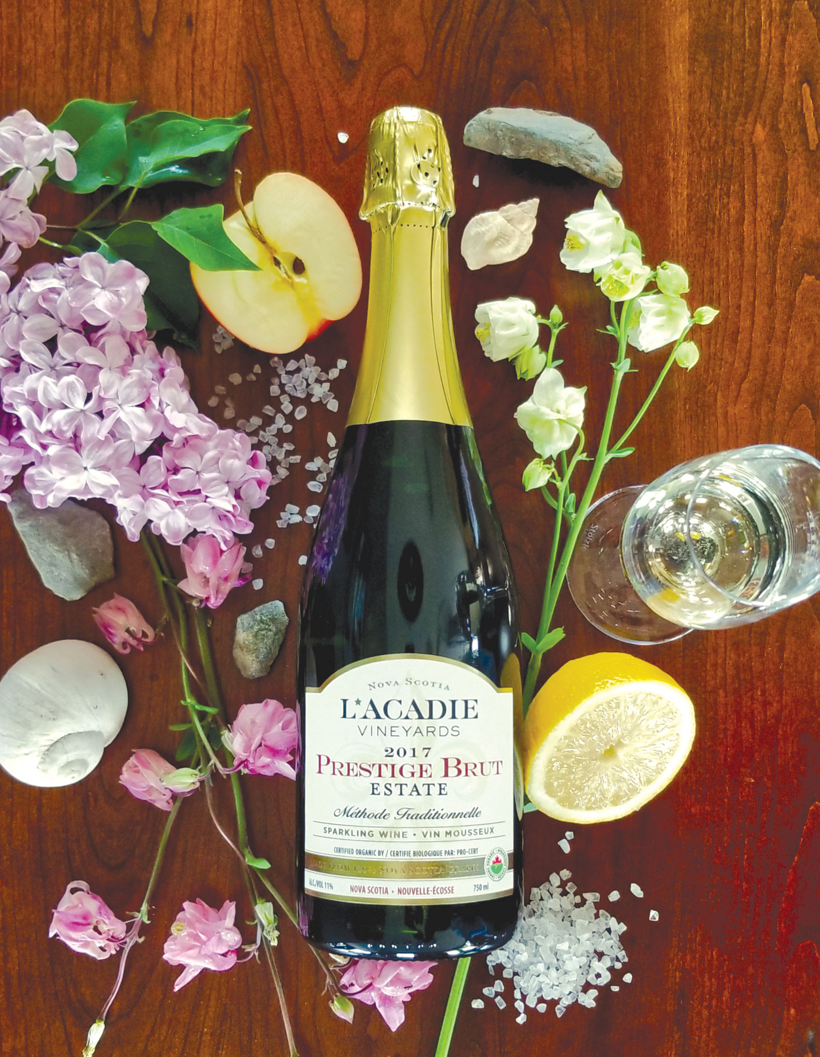 Bottle of Prestige Brut Estate 2017 on table with various items surrounding it