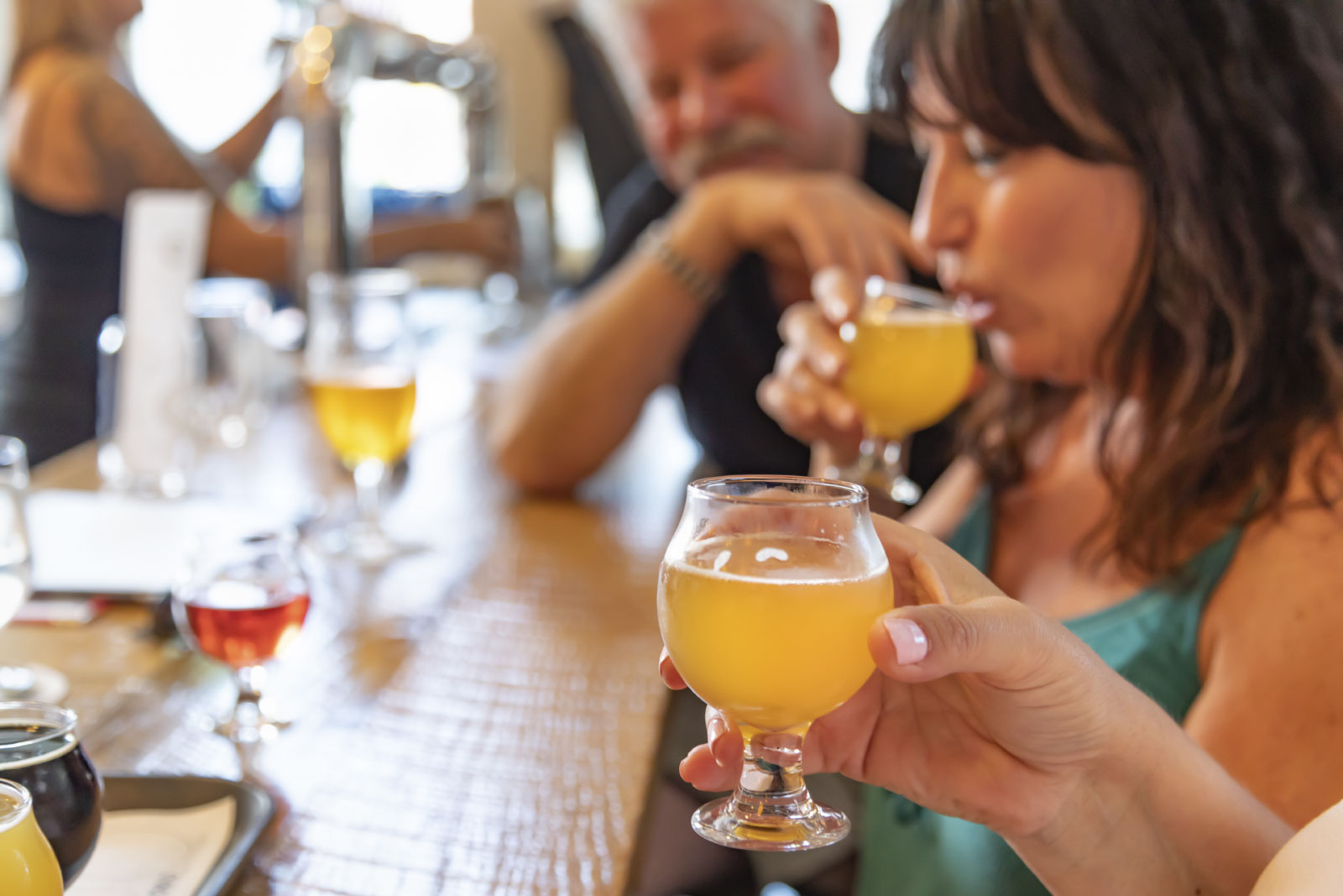Group of friends enjoying glasses of beer at bar
