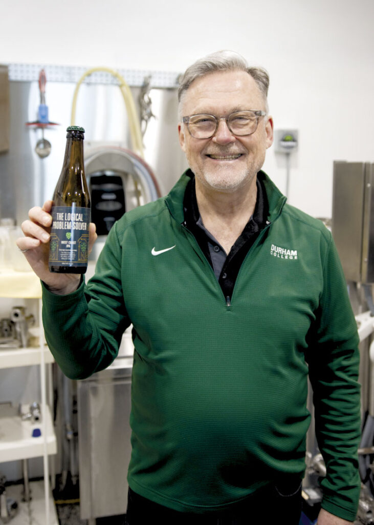 Chris holding bottle of The Logical Problem Solver