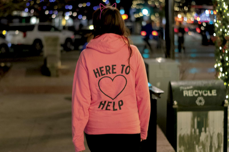 Walking down the street wearing Here to Help hoodie