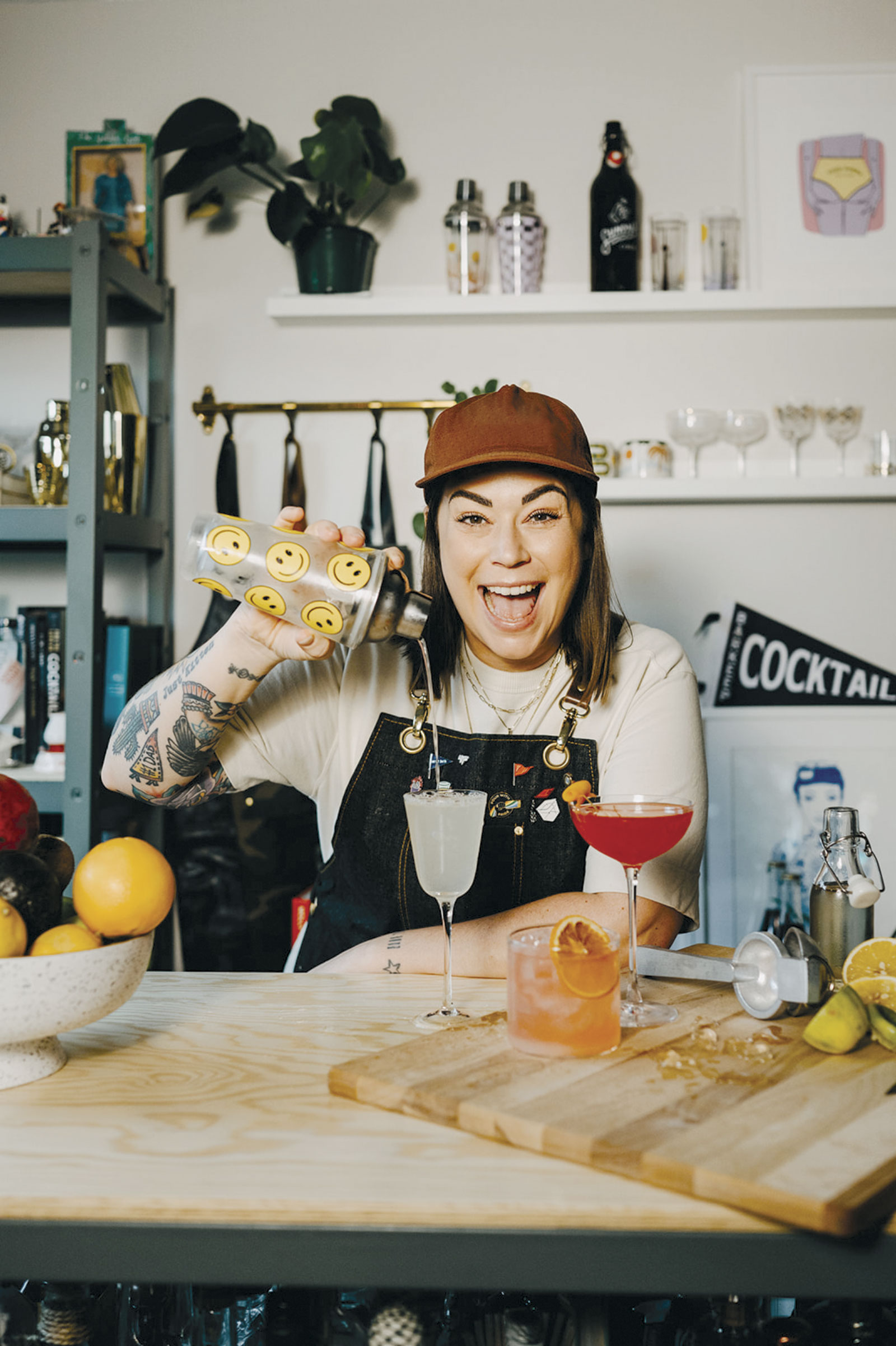 Kaitlyn Stewart straining cocktail from shaker to glass