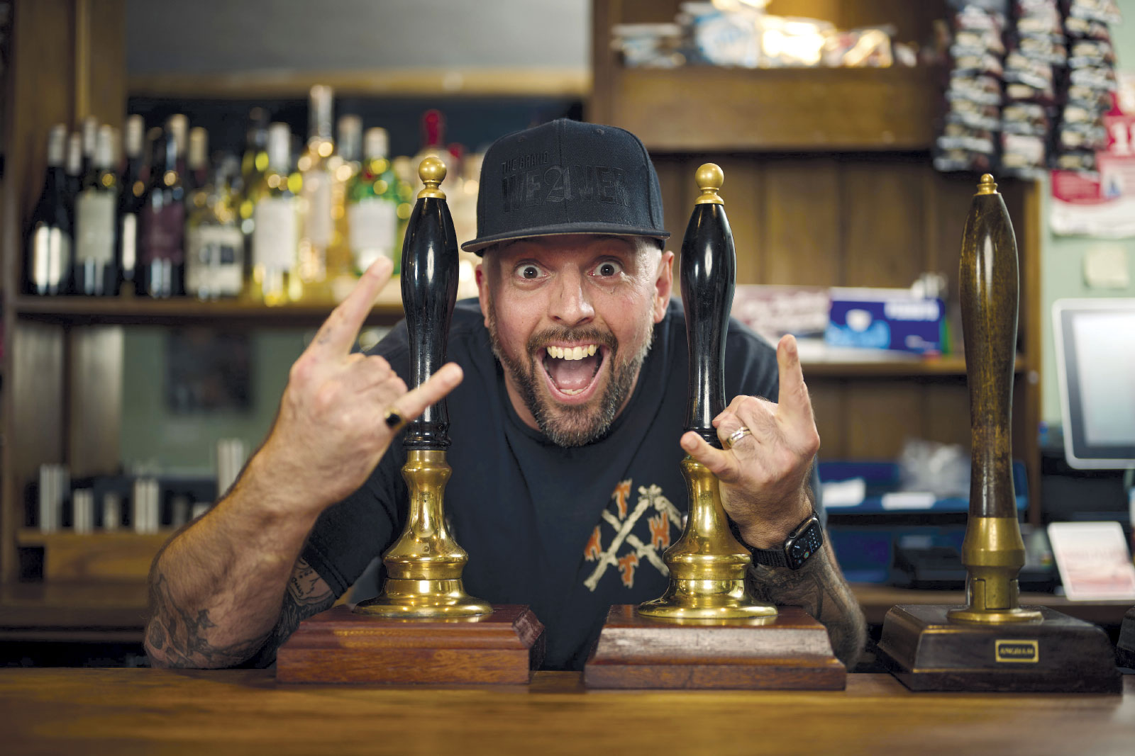 Tim Weaver making face, tucked between two beer taps