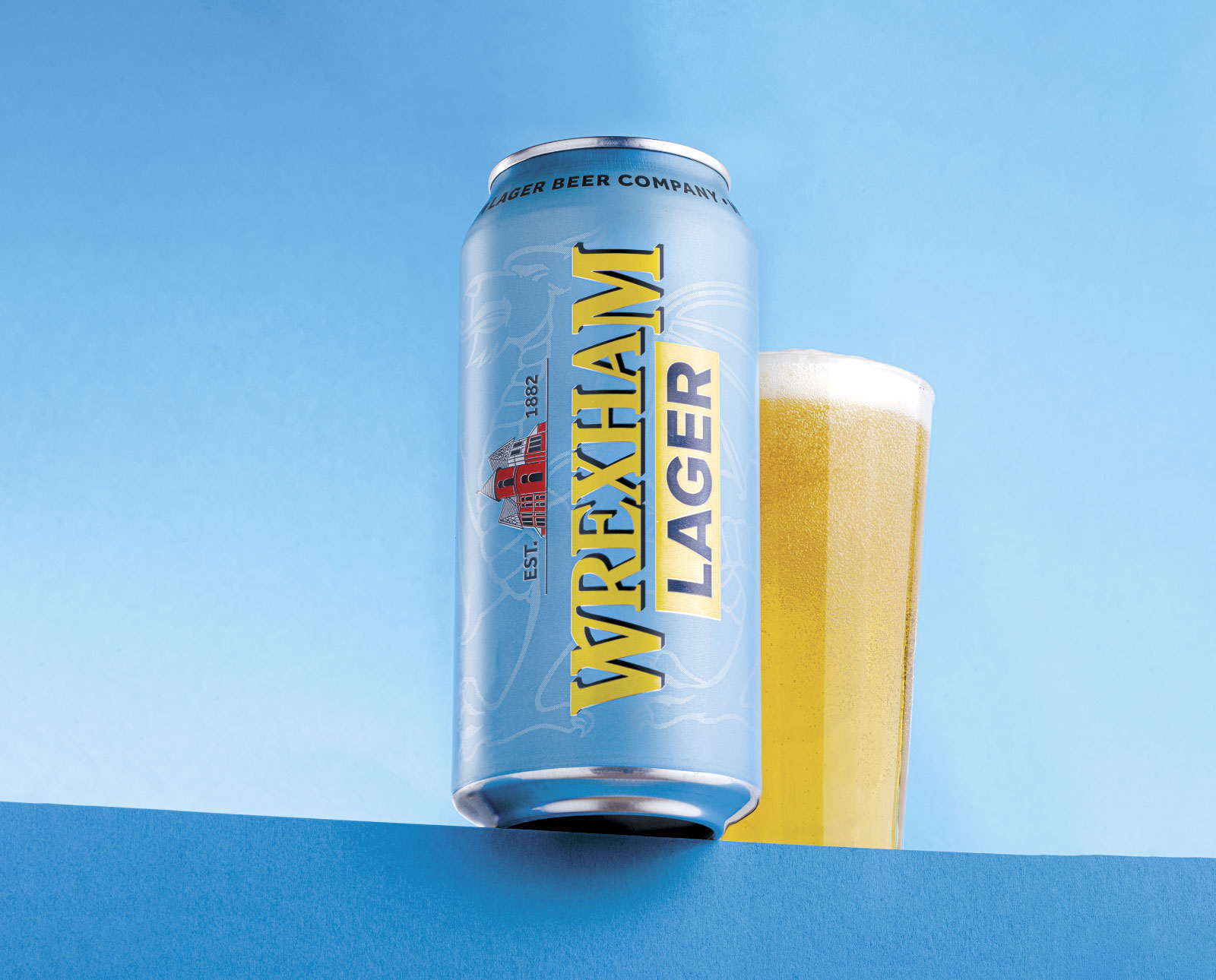 Can of Wrexham Lager with glass of lager in background