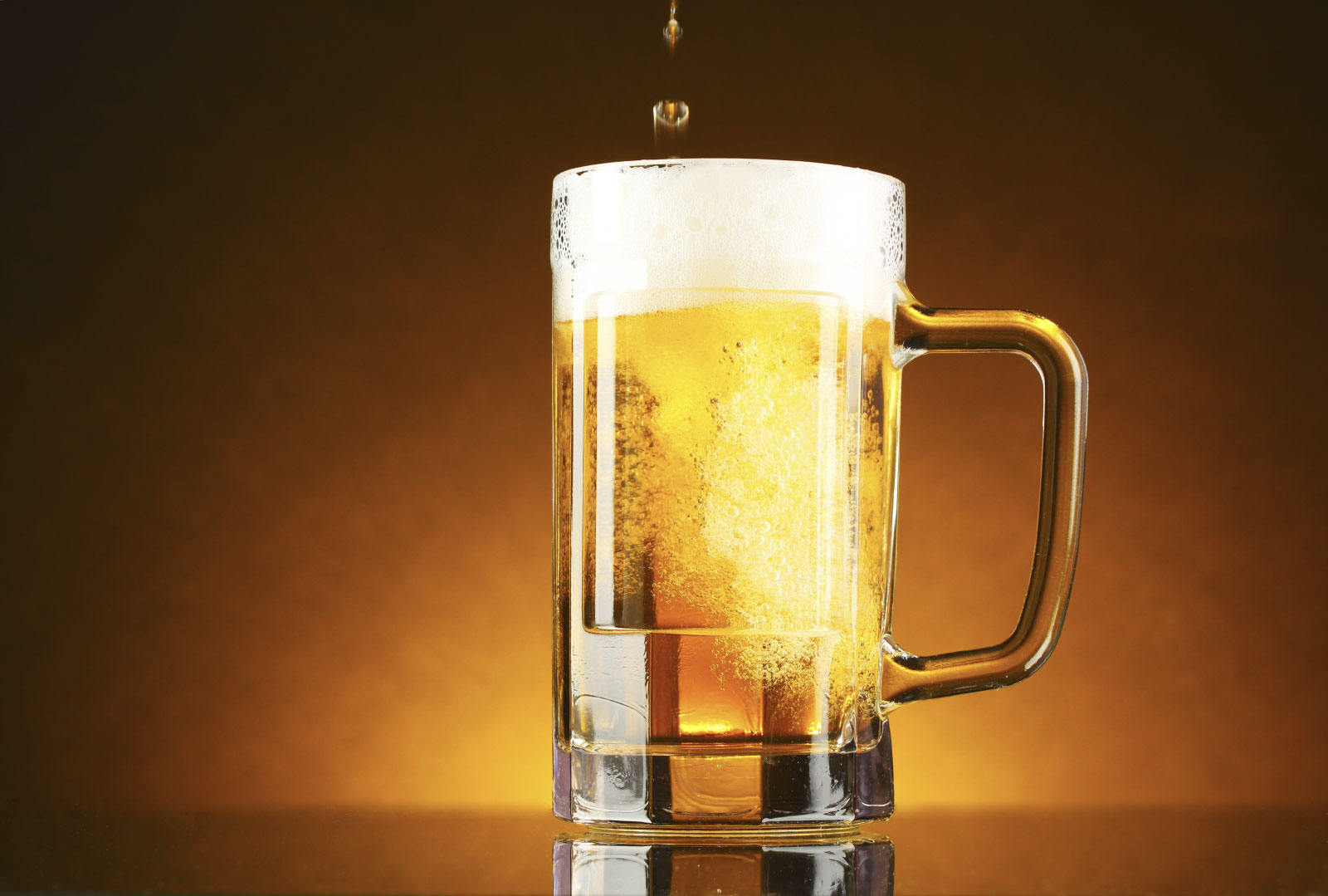 mug of beer on a yellow background