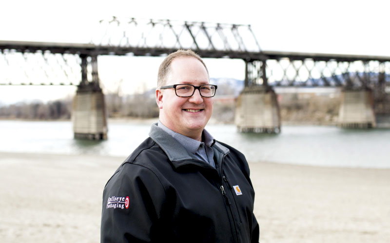 Stephen Peters in foreground, with bridge and river in background