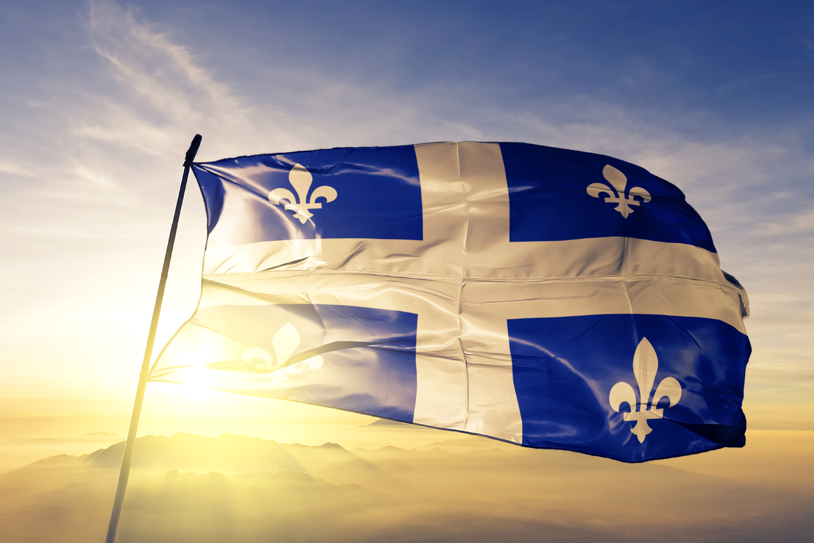 Quebec flag with sun rising (or setting) in background