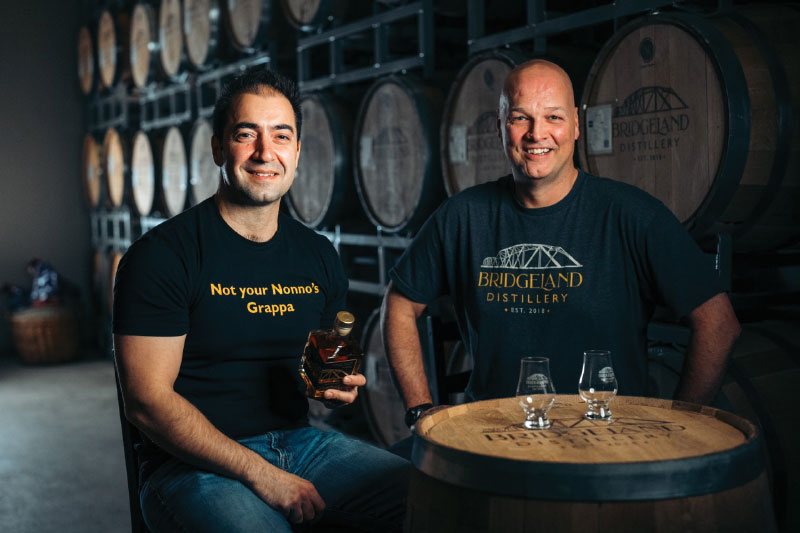 Daniel and Jacques with bottle of whisky and two tasting glasses
