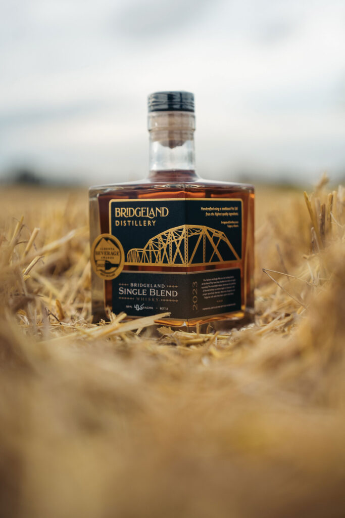 Bottle of Single Blend Whisky in field