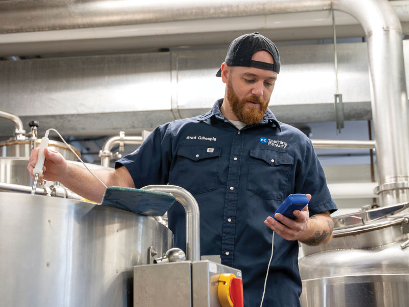 Student testing brew with handheld device