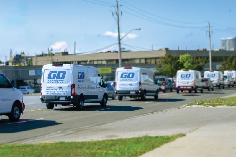 Convoy of GO Logistics van on road