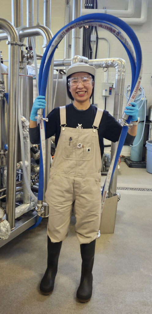 Maria Yun holding hose above head