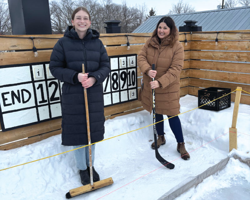 Heidi Arnbjornsson and Ally Giardino smiling for photo on rooftop patio