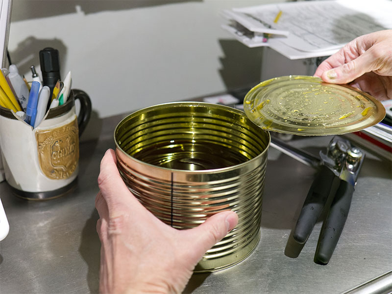 Pulling lid off can of Salvo