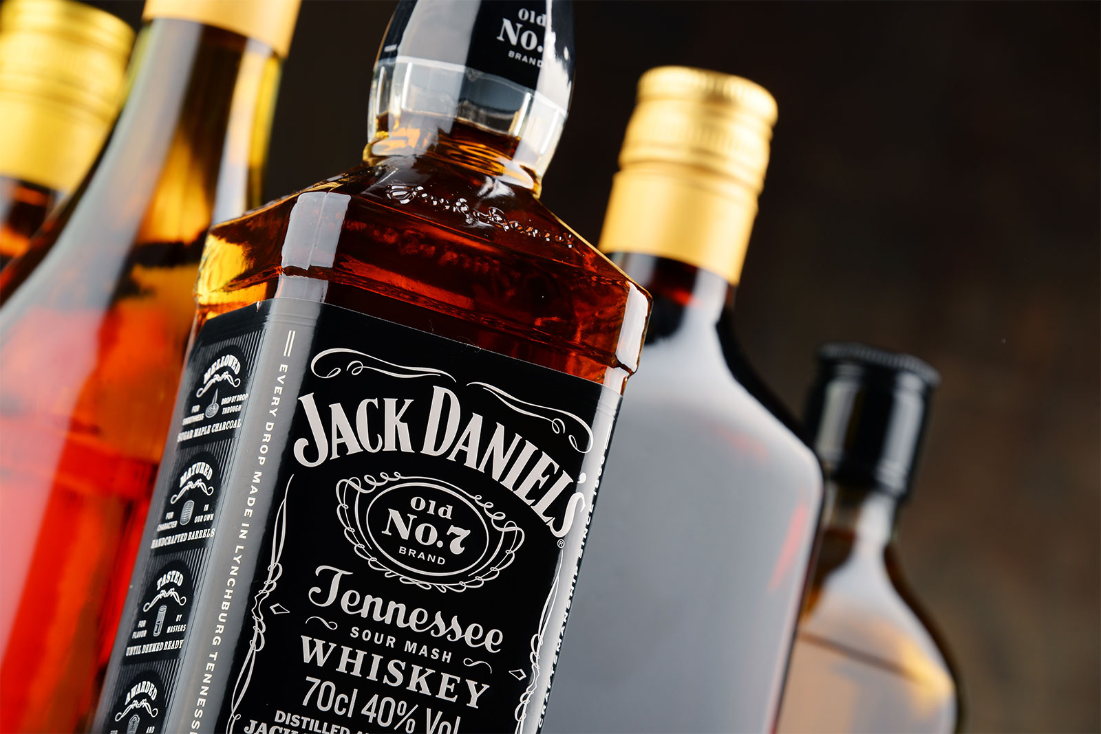 Bottle of Jack Daniel's with various bottles in background
