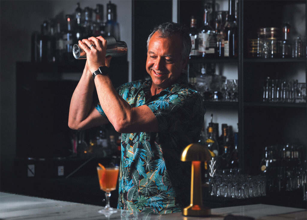 Jason mixes cocktail in shaker