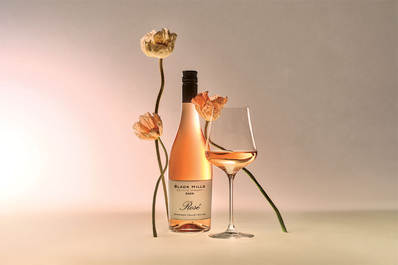 Artistic photo of wine bottle and flowers