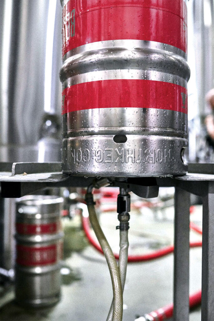 Keg flipped upside down with cleaning tubes attached