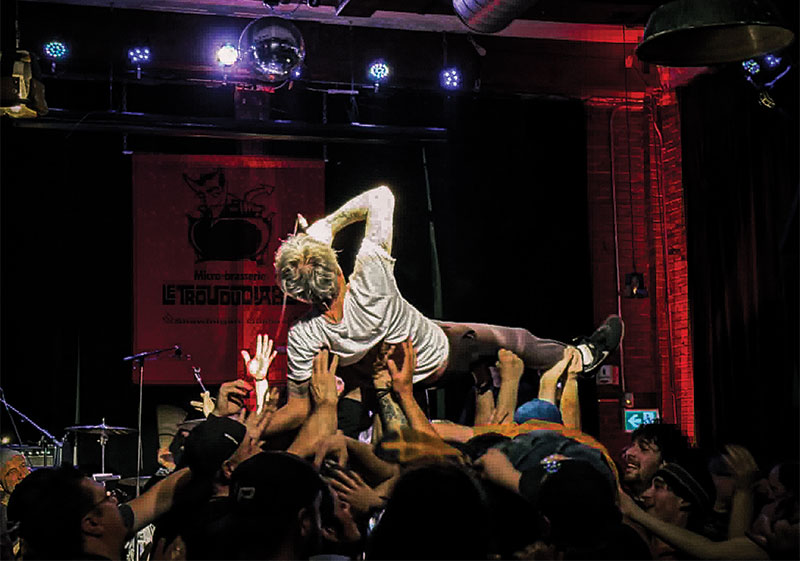 Singer crowd-surfing during performance