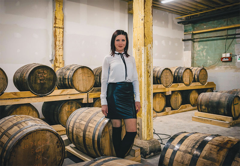 Claudia smiling for photo in barrel room